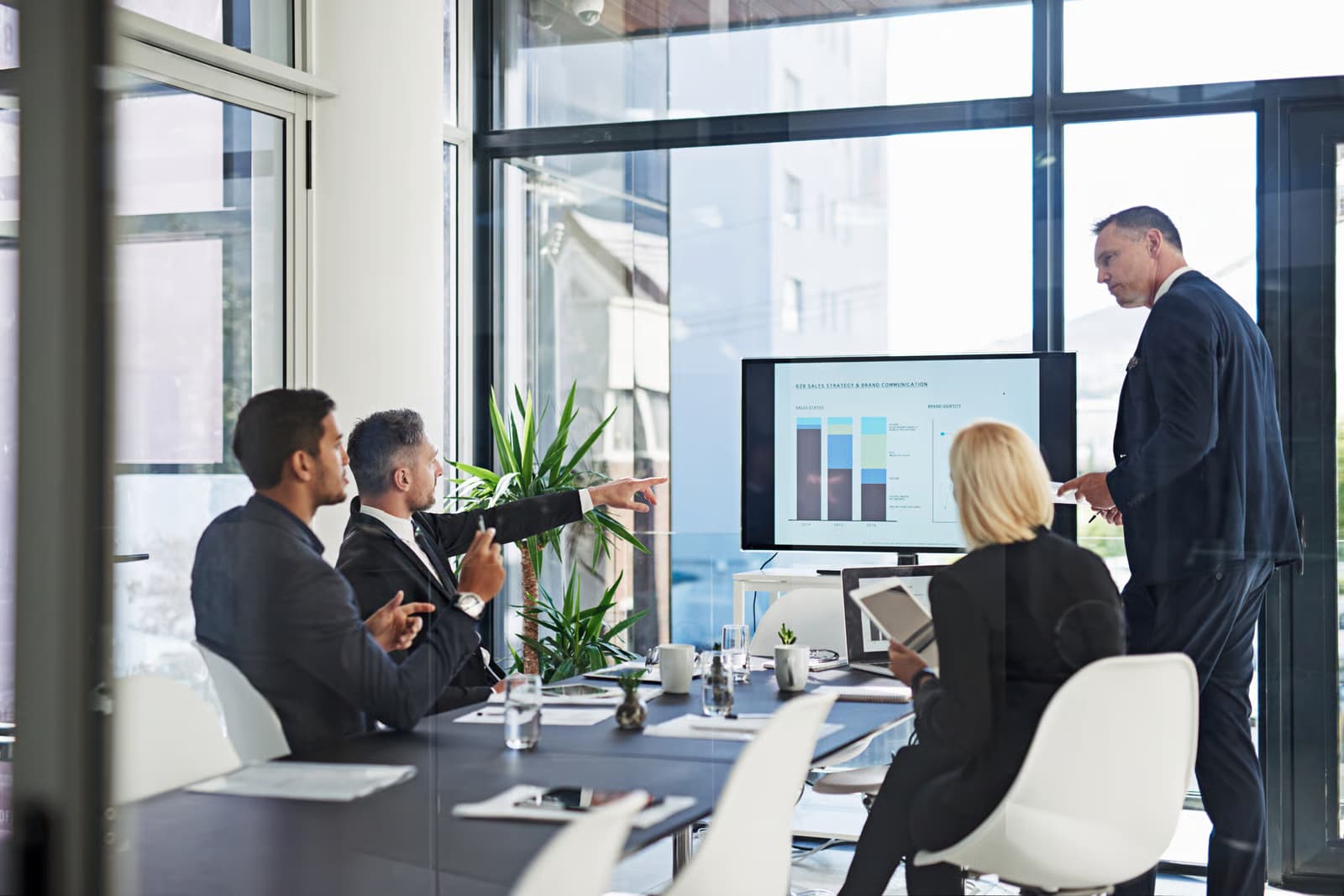 Data analytics consultant reviewing business data with a client on a tablet